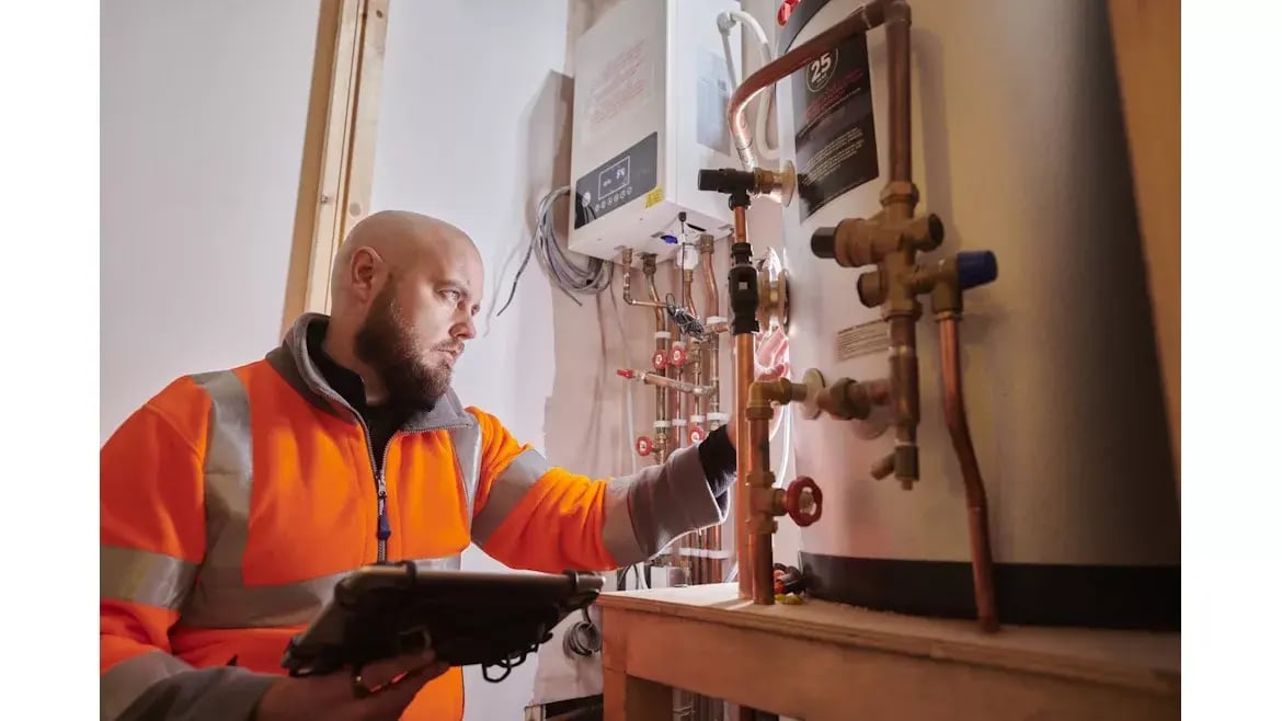 HVAC tech servicing a water heater